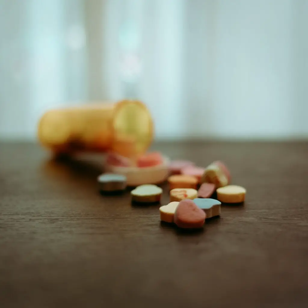 a bottle of pills sitting on top of a wooden table
