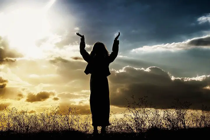 Woman praying with hands in the air